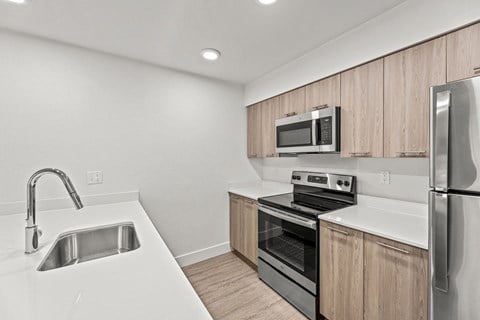 a kitchen with white countertops and wooden cabinets